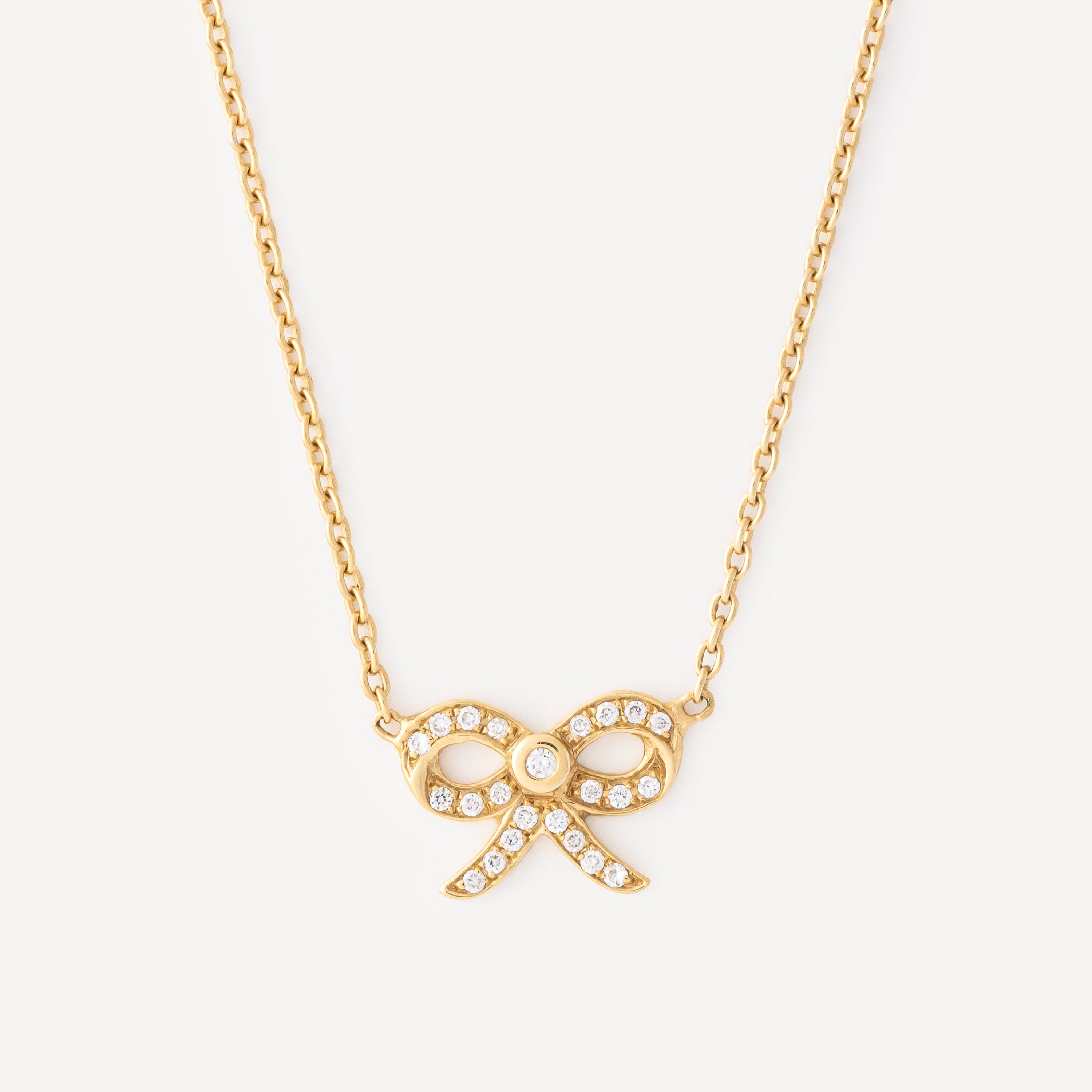 Gold and diamonds mini bow necklace